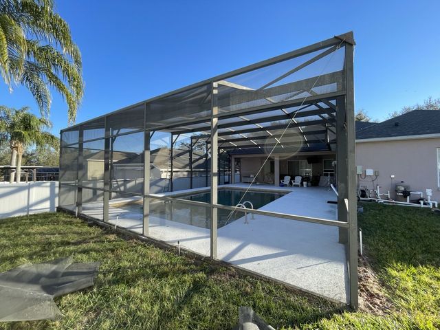 Completed pool cage rescreen on a lakefront Central Florida home
