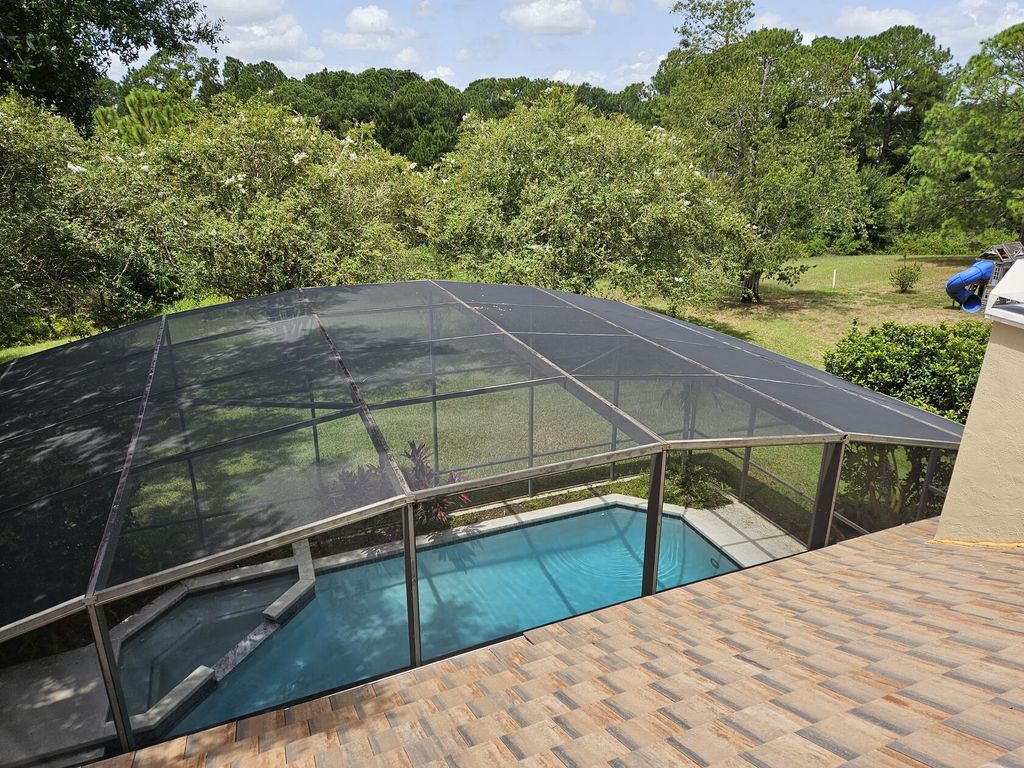Full pool enclosure rescreen on a tile roof home