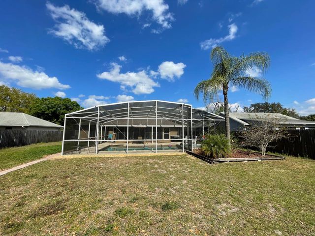 Florida Screen Fix installer rescreening a pool cage from a ladder